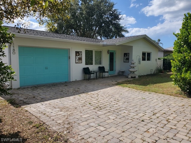 view of front of property with a front yard and a garage