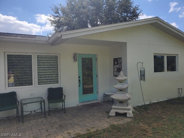 back of property with a patio