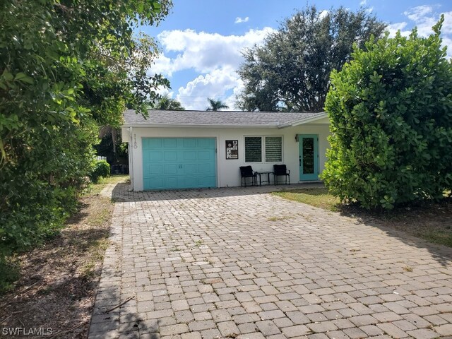 single story home featuring a garage