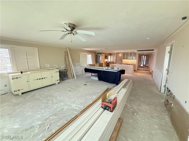 interior space featuring crown molding and ceiling fan