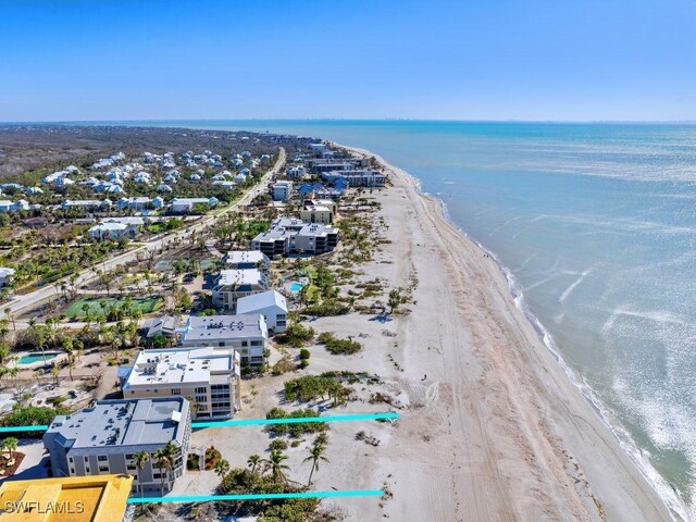 bird's eye view featuring a view of the beach and a water view