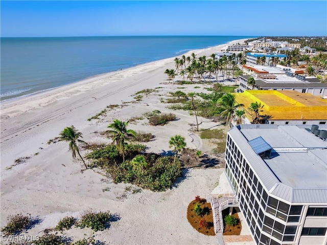 birds eye view of property featuring a water view and a view of the beach