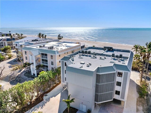 drone / aerial view featuring a water view and a view of the beach