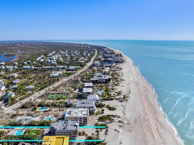 birds eye view of property featuring a view of the beach and a water view