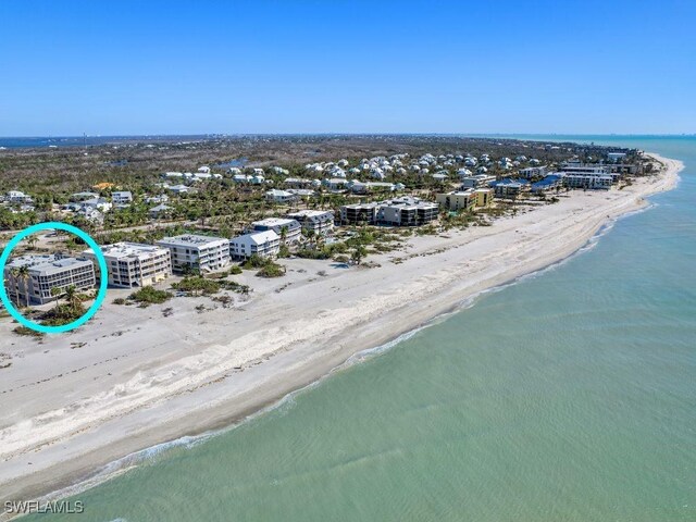 birds eye view of property featuring a view of the beach and a water view