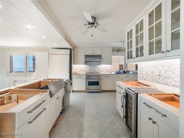 kitchen featuring white cabinetry, stainless steel range, ceiling fan, and decorative backsplash