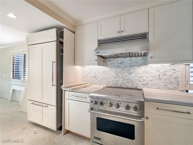 kitchen with backsplash, white cabinets, exhaust hood, and premium appliances