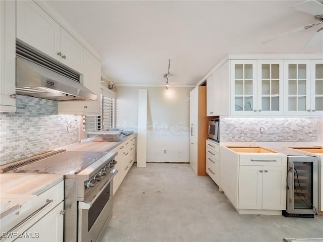 kitchen with ceiling fan, stainless steel appliances, tasteful backsplash, white cabinets, and beverage cooler