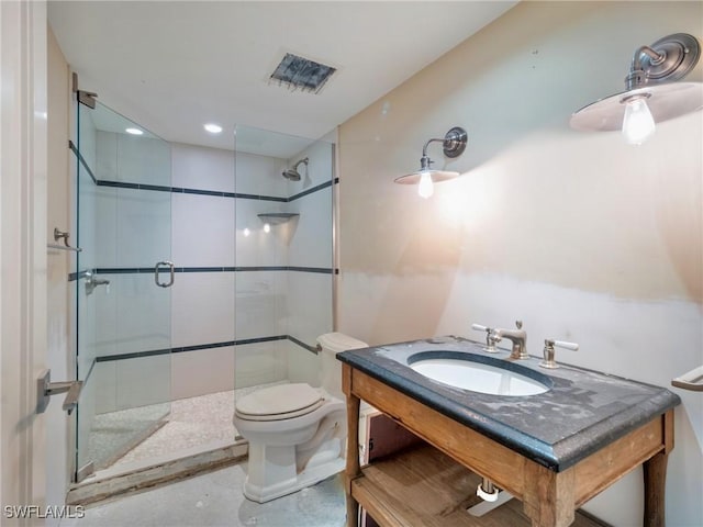 bathroom featuring a shower with door, vanity, and toilet