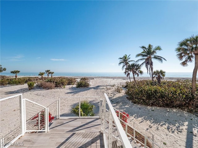 surrounding community featuring a water view and a view of the beach