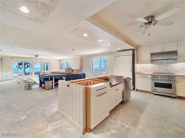 kitchen with sink, ceiling fan, white cabinetry, tasteful backsplash, and stainless steel range