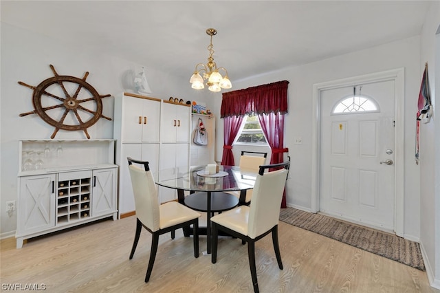 dining area featuring a notable chandelier and light hardwood / wood-style floors