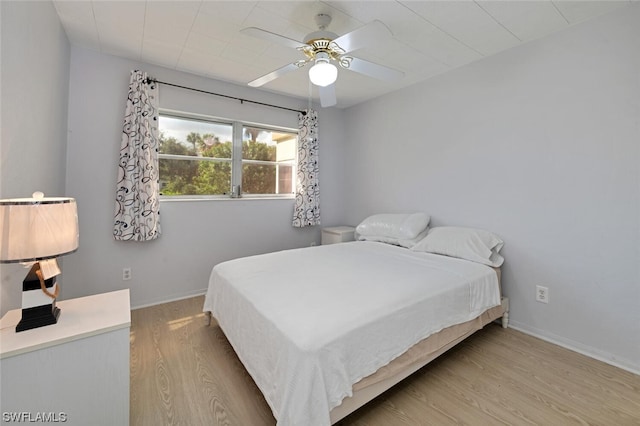 bedroom with ceiling fan and light hardwood / wood-style floors