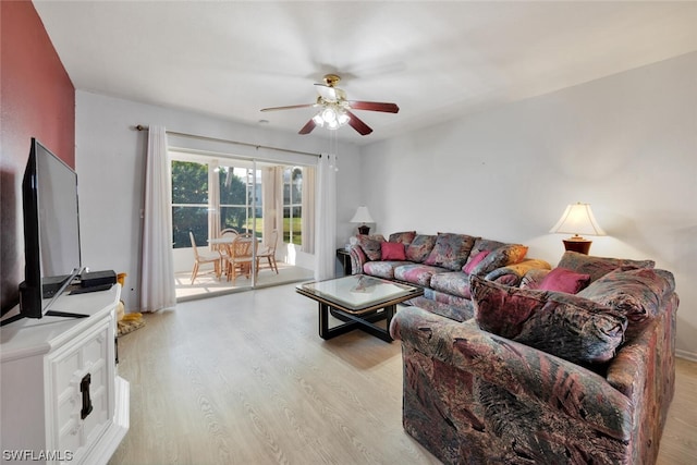 living room featuring ceiling fan and light hardwood / wood-style floors