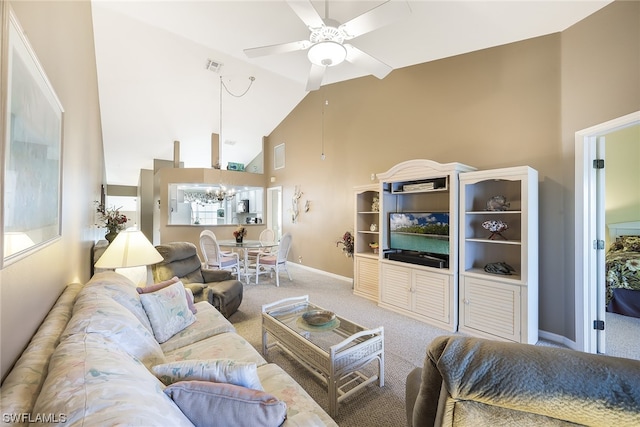 carpeted living room featuring high vaulted ceiling and ceiling fan with notable chandelier