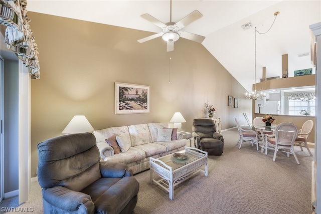 living room with high vaulted ceiling, ceiling fan with notable chandelier, and light colored carpet