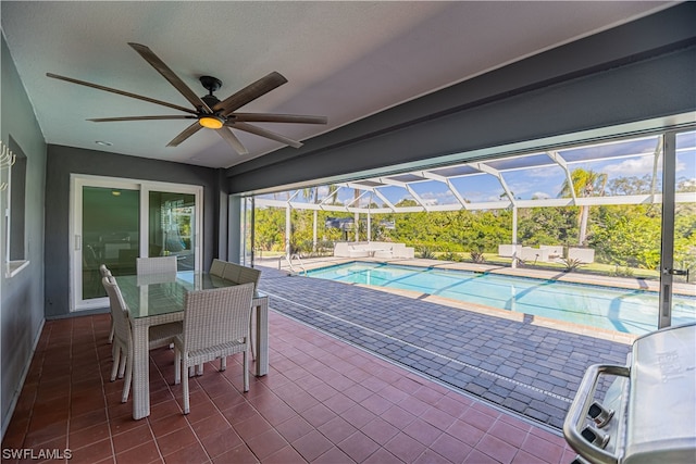 view of pool with ceiling fan, a patio, and a lanai