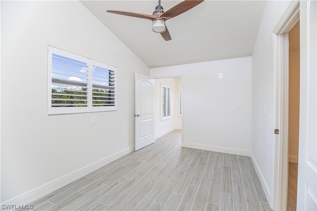 unfurnished room with light hardwood / wood-style floors, ceiling fan, and vaulted ceiling