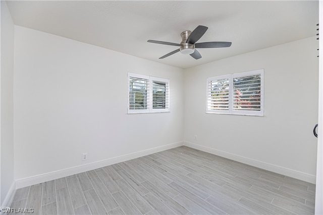 spare room featuring ceiling fan and light hardwood / wood-style flooring