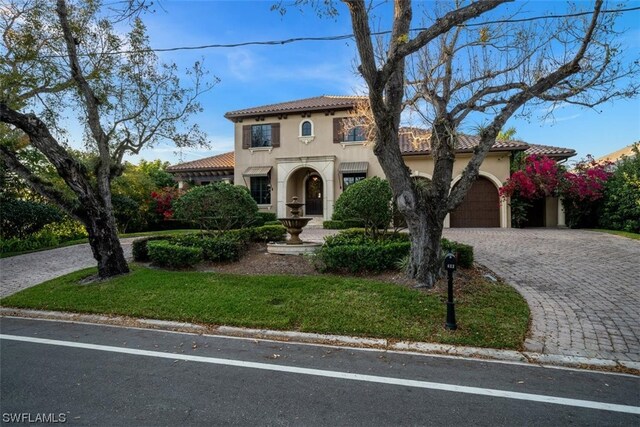 mediterranean / spanish-style house featuring a garage