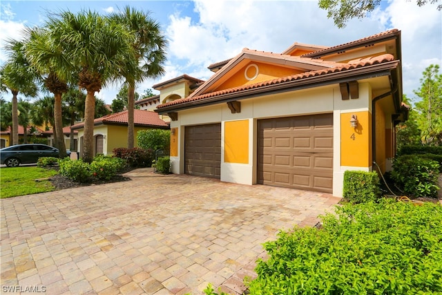 mediterranean / spanish house with a garage