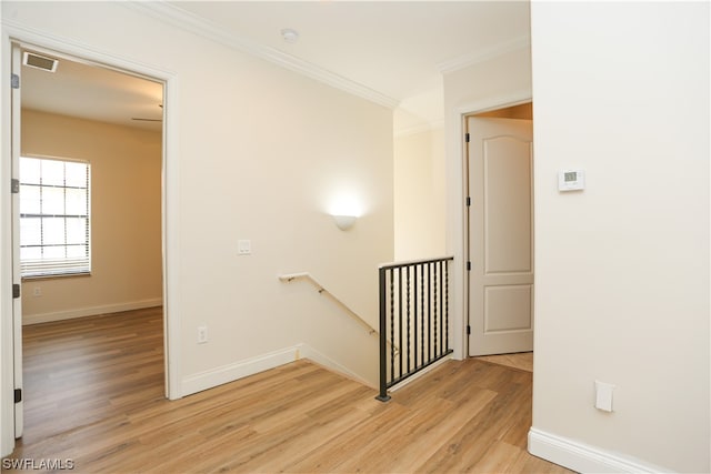 hall featuring ornamental molding and light wood-type flooring