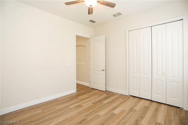 unfurnished bedroom featuring a closet, ceiling fan, and light hardwood / wood-style flooring