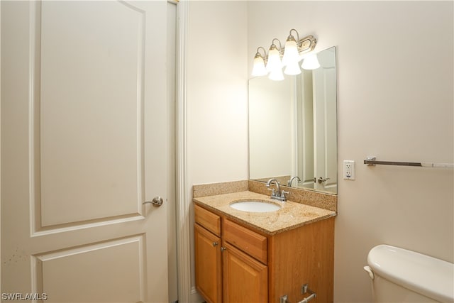 bathroom featuring toilet and vanity