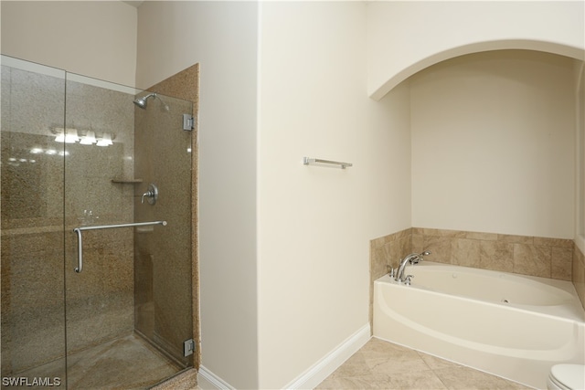 bathroom with tile floors, toilet, and separate shower and tub