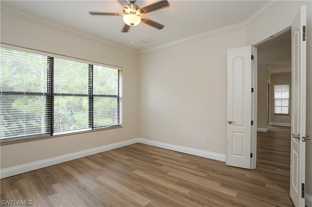 spare room featuring ornamental molding, ceiling fan, and dark hardwood / wood-style flooring