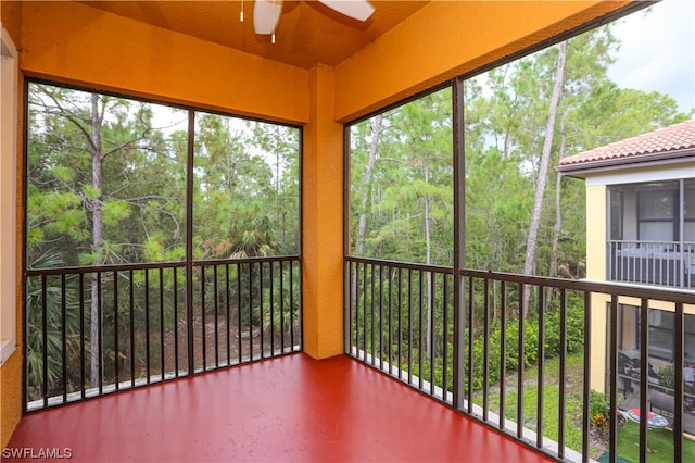 unfurnished sunroom featuring ceiling fan