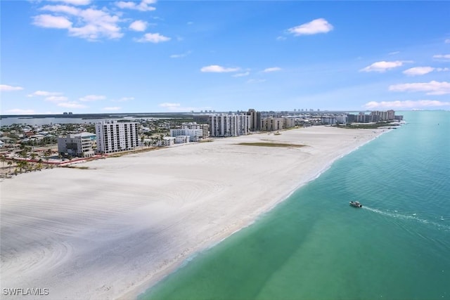 drone / aerial view featuring a view of the beach and a water view