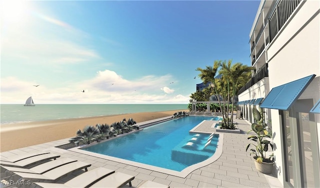 view of swimming pool featuring a water view, a patio area, and a view of the beach