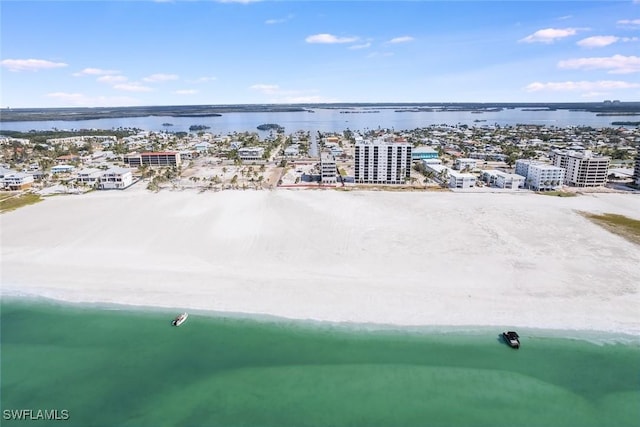 bird's eye view with a city view, a water view, and a beach view