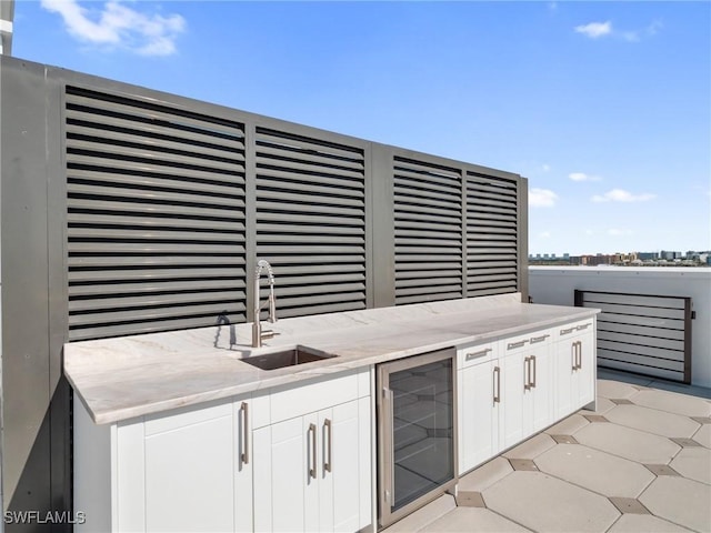 view of patio featuring a sink, wine cooler, and an outdoor kitchen