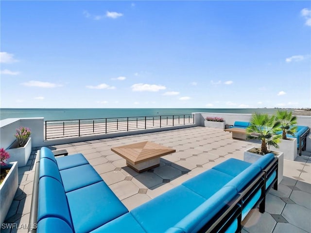 view of patio / terrace featuring a water view and an outdoor living space