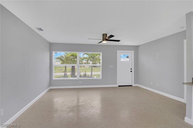 unfurnished living room with ceiling fan