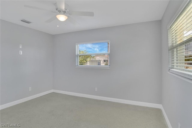 unfurnished room with ceiling fan and a wealth of natural light