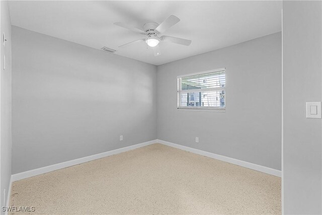 2 Fairview Blvd, Fort Myers Beach, FL 33931 - spare room with speckle patterned floor, baseboards, and ceiling fan