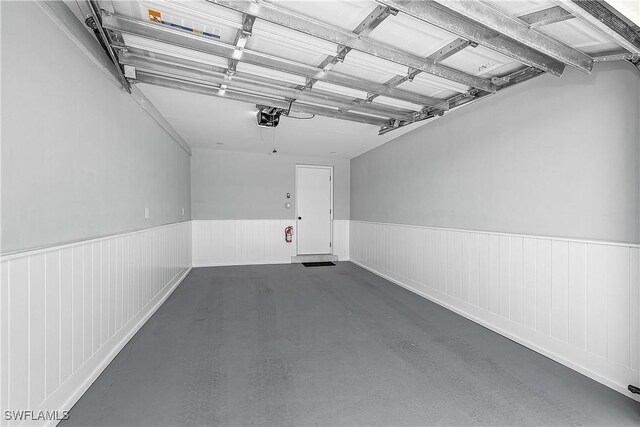 2 Fairview Blvd, Fort Myers Beach, FL 33931 - garage featuring wainscoting and a garage door opener