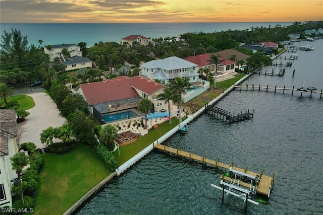 aerial view at dusk with a water view