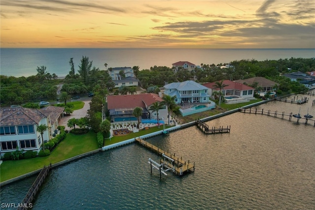 aerial view at dusk with a water view