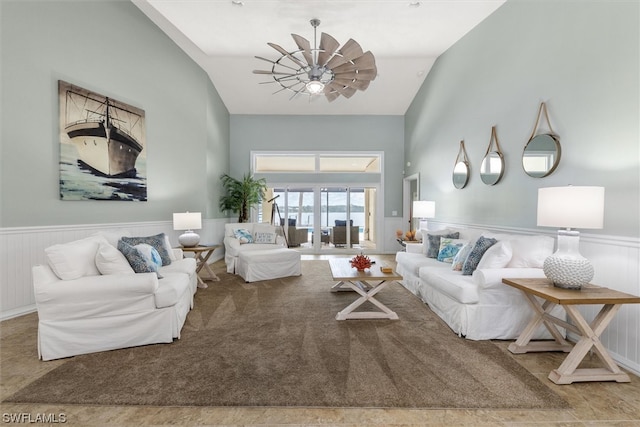 living room featuring vaulted ceiling and ceiling fan