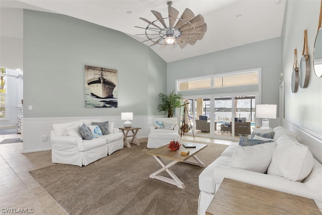 tiled living room with vaulted ceiling and ceiling fan