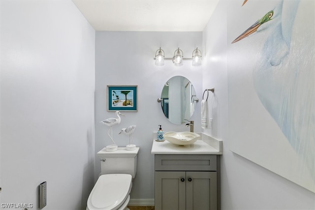 bathroom featuring oversized vanity and toilet