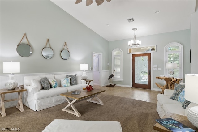 living room featuring an inviting chandelier, light carpet, and vaulted ceiling