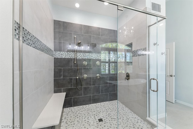 bathroom with a shower with door