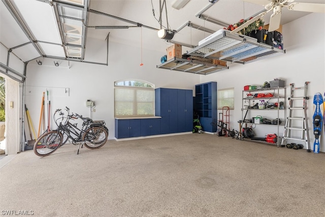 garage with a garage door opener and ceiling fan