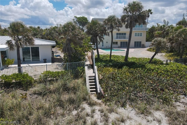 exterior space featuring a fenced in pool and a patio area