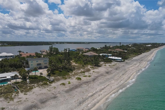 birds eye view of property with a water view and a view of the beach